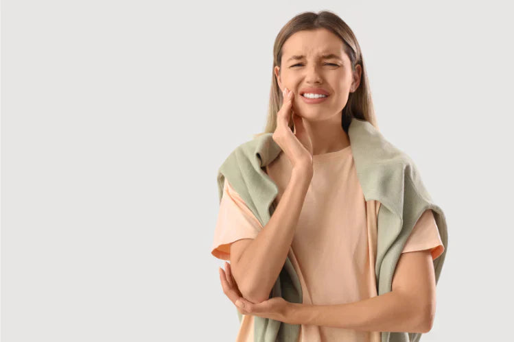 A girl is suffering from a toothache.